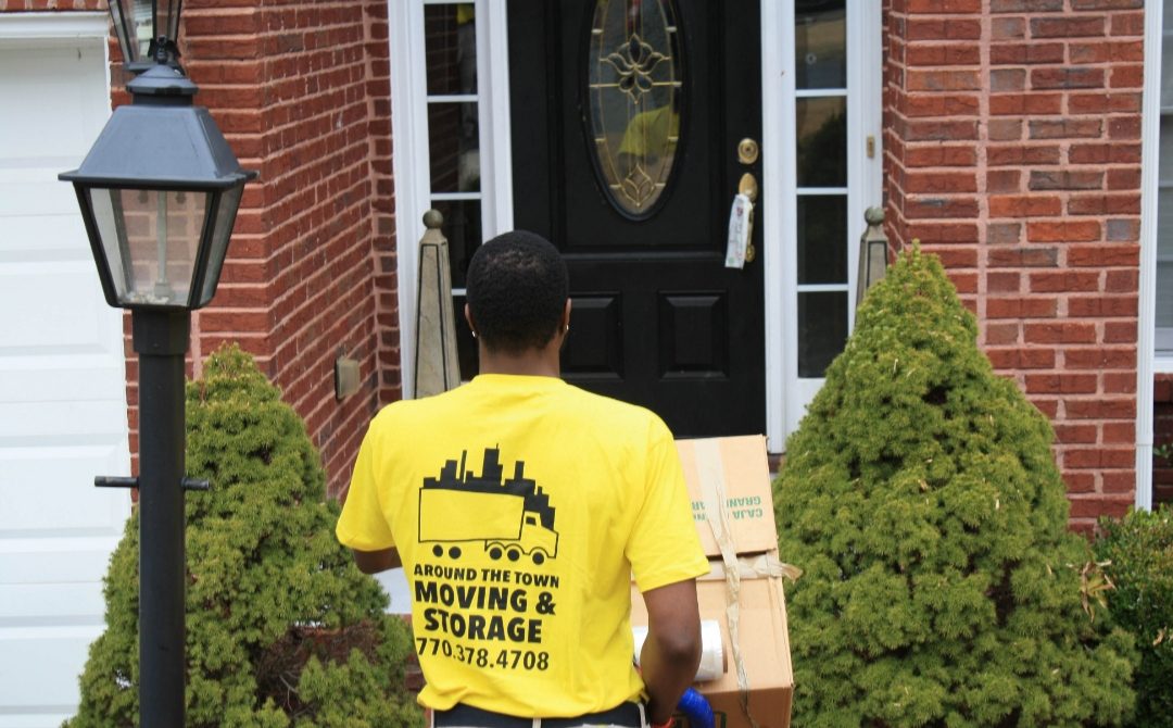 Mover carrying boxes to a front door