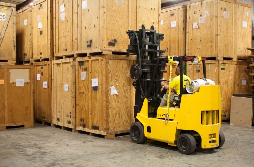 Forklift moving storage vaults