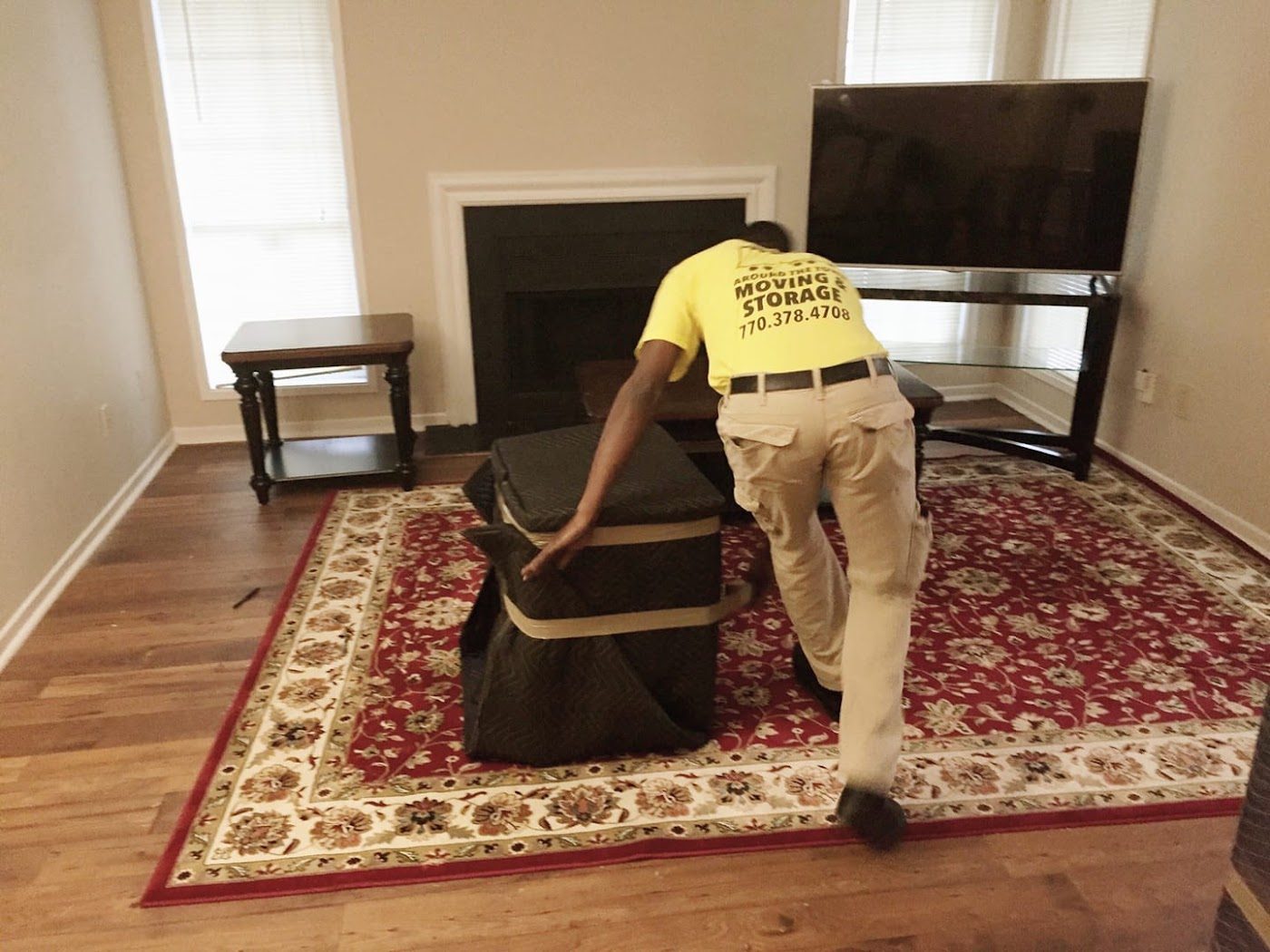Mover setting up furniture in a living room
